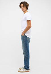 Tricou Allen alb, lateral, purtat pe model, cu blugi albaștri